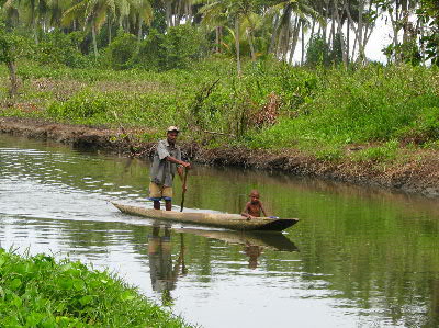 Man and boy traveling via canoe canal