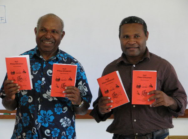 Huli Men showing off dictionary